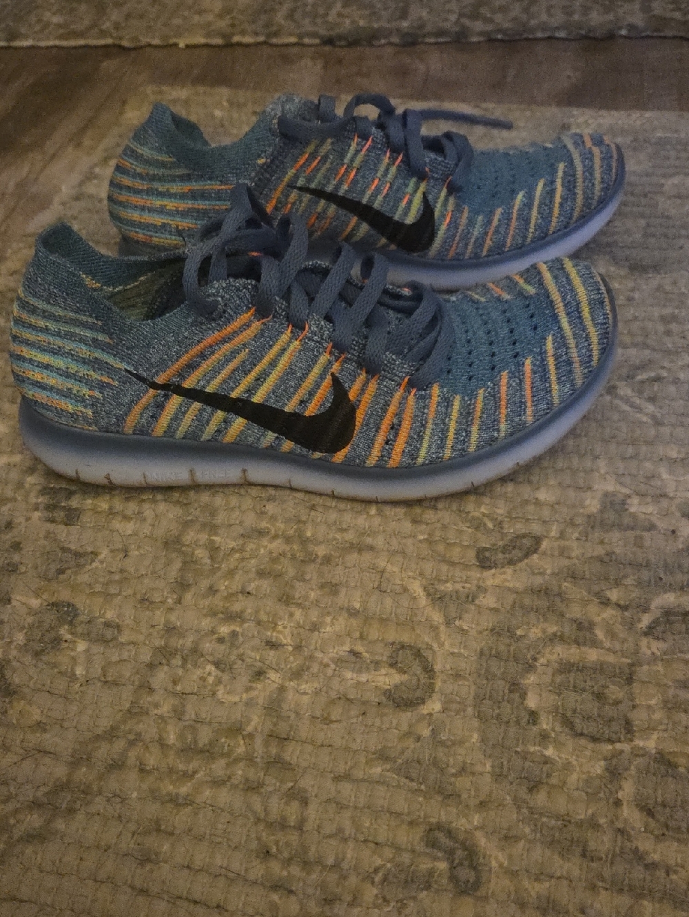 Nike Kids Blue Flyknit Sneakers with Orange and Yellow Stripes